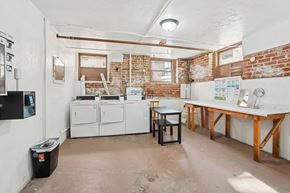 Torrance apartment for rent - A room with a white table and a brick wall.